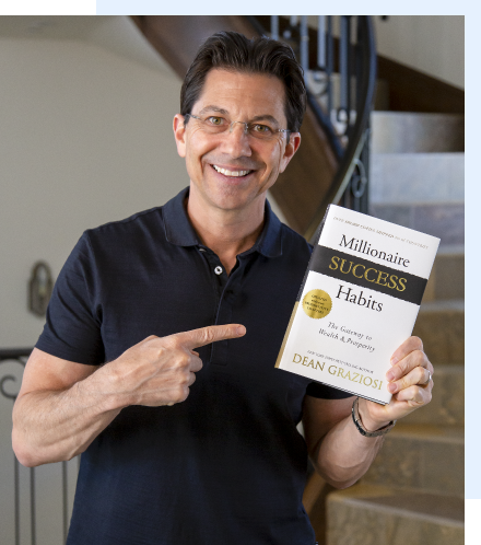 Dean Graziosi holding his NY Best Selling book Millionaire Success Habits